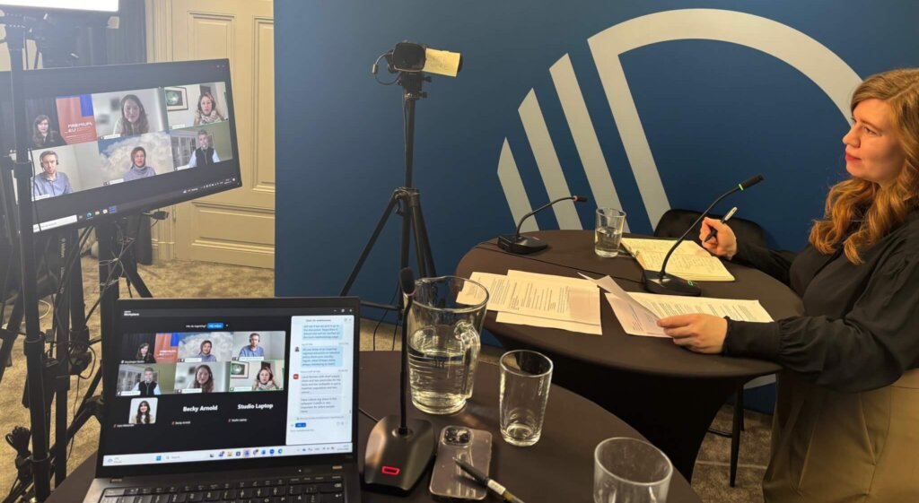 Moderator in the studio speaking to online panellists